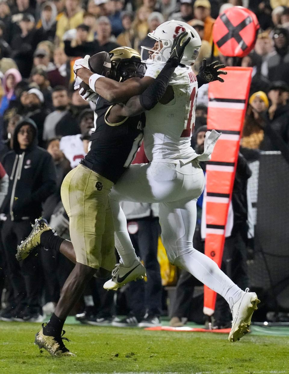 Stanford wide receiver Elic Ayomanor, right, catches a pass for a touchdown over Colorado cornerback Travis Hunter in overtime of an NCAA college football game early Saturday, Oct. 14, 2023, in Boulder, Colo.