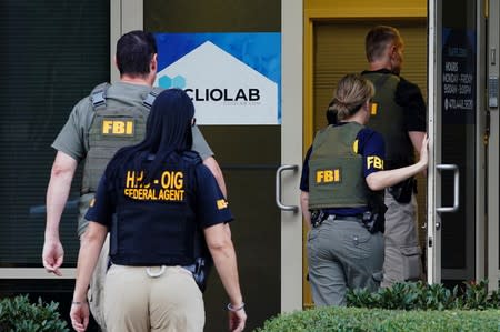 Federal agents execute a search warrant on Clio Laboratories in Lawrenceville