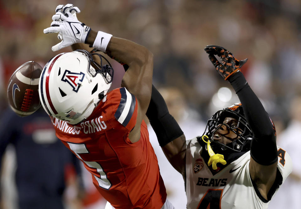 Oregon State defensive back Jaden Robinson (4) gets a hand in the face of Arizona wide receiver Montana Lemonious-Craig (5), breaking up a pass during the second quarter of an NCAA college football game Saturday, Oct. 28, 2023, in Tucson, Ariz. (Kelly Presnell/Arizona Daily Star via AP)