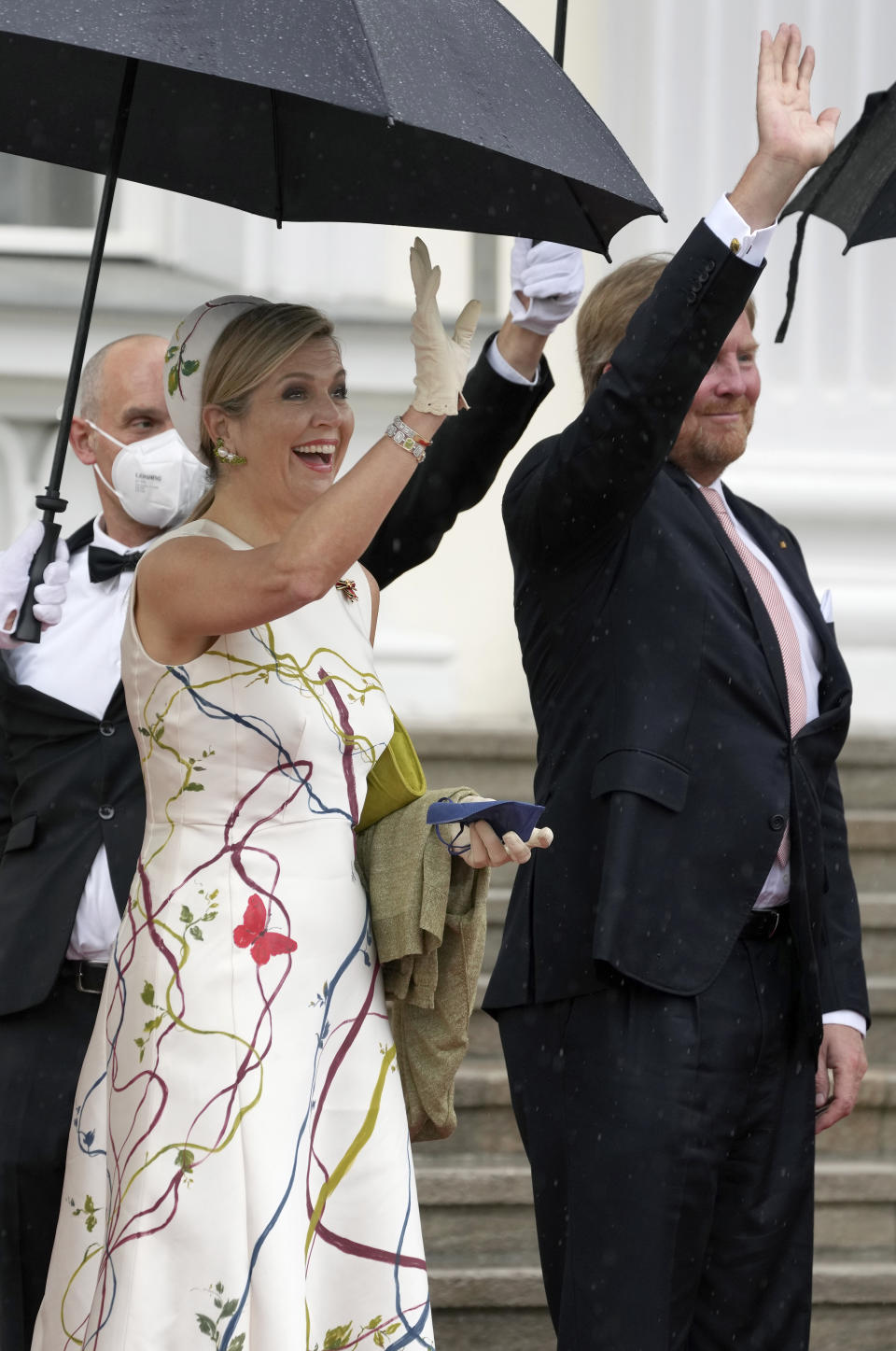 Dutch King Willem-Alexander, right and his wife Queen Maxima, front left, wave as they arrive for a meeting with German President Frank-Walter Steinmeier in Berlin, Germany, Monday, July 5, 2021. King Willem-Alexander and Queen Maxima are on a three day visit in Germany. (AP Photo/Michael Sohn)