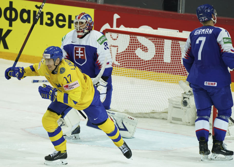 Par Lindholm of Sweden, left, celebrates goal during the Ice Hockey World Championship group A match between the Sweden and Slovakia at the Olympic Sports Center in Riga, Latvia, Sunday, May 30, 2021. (AP Photo/Oksana Dzadan)