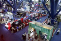 Visitors mill about the exhibitors booths in the main exhibition hall at the National Rifle Association Annual Meeting at the George R. Brown Convention Center, Friday, May 27, 2022, in Houston. (AP Photo/Michael Wyke)