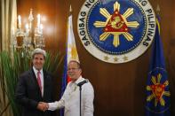 U.S. Secretary of State John Kerry (L) and Philippines' President Benigno Aquino shake hands at a dinner at the Malacanang Presidential Palace in Manila December 17, 2013. (REUTERS/Brian Snyder)