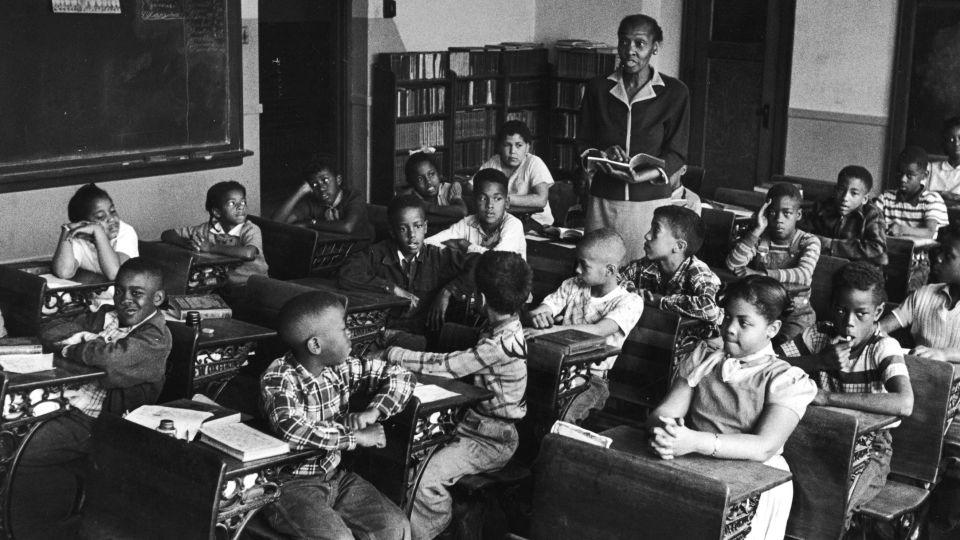Inside a classroom at Monroe Elementary School in Topeka, Kansas in March 1953. Among the students are Linda Brown, bottom right, and her sister Terry Lynn, far left row, second from front, who, with their parents, initiated the Brown v. Board of Education. - Carl Iwasaki/Getty Images