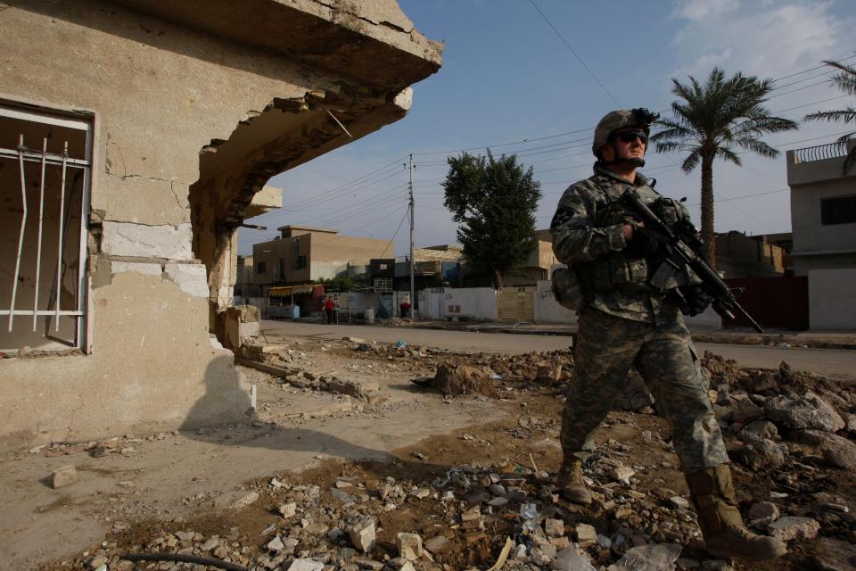 Army 2nd Battalion, 12th Infantry Regiment, Baker Company PFC Jonathan Burton of Louisville, Kentucky, patrols in the mahallah (neighborhood) of Toma on the outskirts of Baghdad at the corner where on June 28, 2007, a Baker Company patrol was hit by an IED in Toma and five soldiers were killed along with 13 wounded.