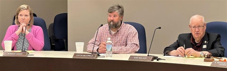 Spartanburg County Council members Justin McCorkle, center, and Bob Walker, right, voiced support Tuesday for extending a penny sales tax to pay for road fixes when the current one that paid for a new county courthouse expires next year.