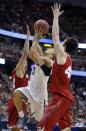 Arizona guard Nick Johnson, middle, drives past Wisconsin guard Traevon Jackson, left, and forward Frank Kaminsky during the first half in a regional final NCAA college basketball tournament game, Saturday, March 29, 2014, in Anaheim, Calif. (AP Photo/Alex Gallardo)