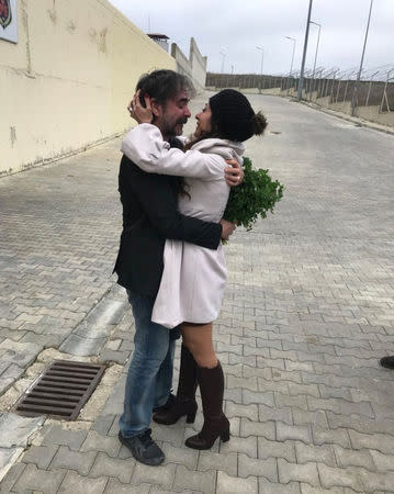 German-Turkish journalist Deniz Yucel hugs his wife, Dilek Mayatuerk, after he was released from prison in Istanbul, Turkey February 16, 2018, in this handout photo obtained from social media. Mandatory credit. TWITTER/VEYSEL OK/Handout via REUTERS