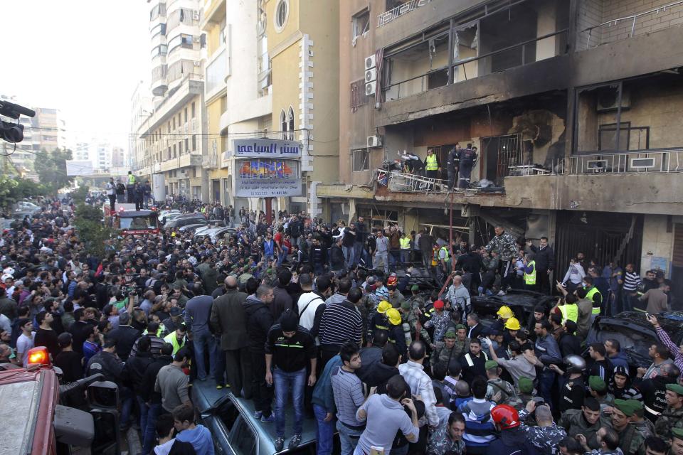 People gather at the site of a bomb blast in the Haret Hreik area, in the southern suburbs of the Lebanese capital Beirut