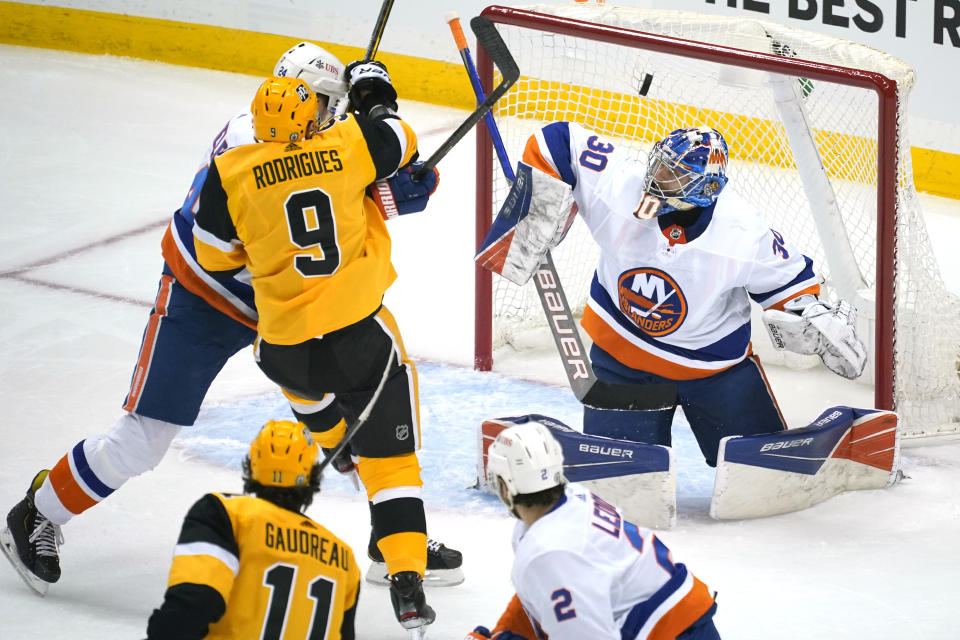 Pittsburgh Penguins' Frederick Gaudreau (11) puts a shot over New York Islanders goaltender Ilya Sorokin (30) for a goal during the first period of Game 1 of an NHL hockey Stanley Cup first-round playoff series in Pittsburgh, Sunday, May 16, 2021. (AP Photo/Gene J. Puskar)