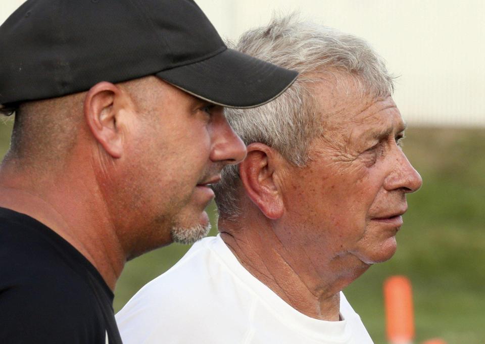 Jason France (left), a Manchester assistant coach, and his dad, Panthers coach Jim France, watch the action during a scrimmage between Manchester and Ellet at James R. France Stadium on Aug. 15, 2017, in New Franklin.
