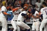 Houston Astros' Jose Altuve (27) celebrates with teammates after hitting a game-winning grand slam during the 10th inning of a baseball game against the Texas Rangers Tuesday, June 15, 2021, in Houston. The Astros won 6-3. (AP Photo/David J. Phillip)