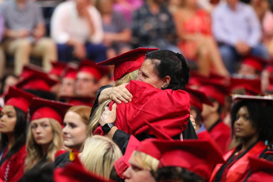 A Creekside High graduate offers a hug during graduation, Saturday, May 28, 2022, at UNF Arena.