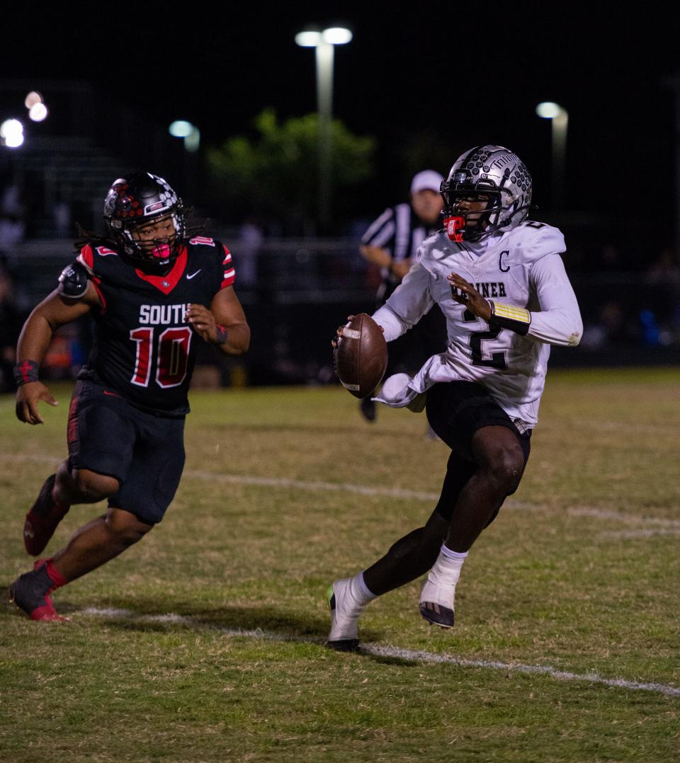 Mariner's Justin Lewis looks for a receiver as South Fort Myers Quarice Vance closes the gap during Friday's game