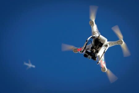 FILE PHOTO: An airplane flies over a drone during the Polar Bear Plunge on Coney Island in the Brooklyn borough of New York, U.S., January 1, 2015.   REUTERS/Carlo Allegri/File Photo