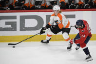 Philadelphia Flyers right wing Wade Allison (57) skates with the puck past Washington Capitals left wing Conor Sheary (73) during the first period of an NHL hockey game Saturday, May 8, 2021, in Washington. (AP Photo/Nick Wass)