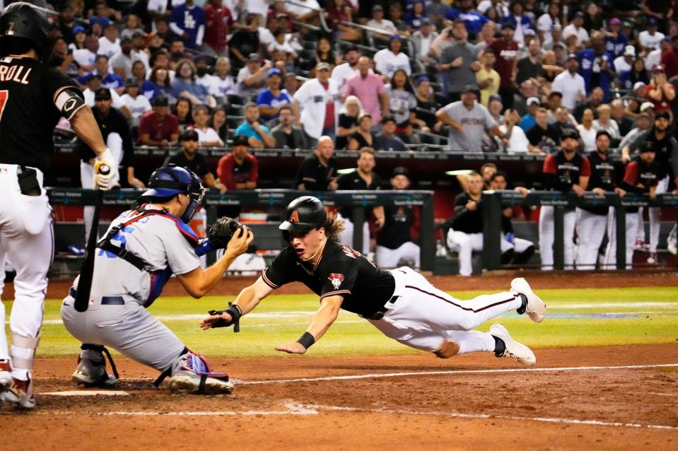 Sep 14, 2022; Phoenix, Arizona, USA; Los Angeles Dodgers catcher Austin Barnes (15) tags out Arizona Diamondbacks Jake McCarthy (30) trying to steal home plate in the ninth inning at Chase Field. Mandatory Credit: Rob Schumacher-Arizona Republic