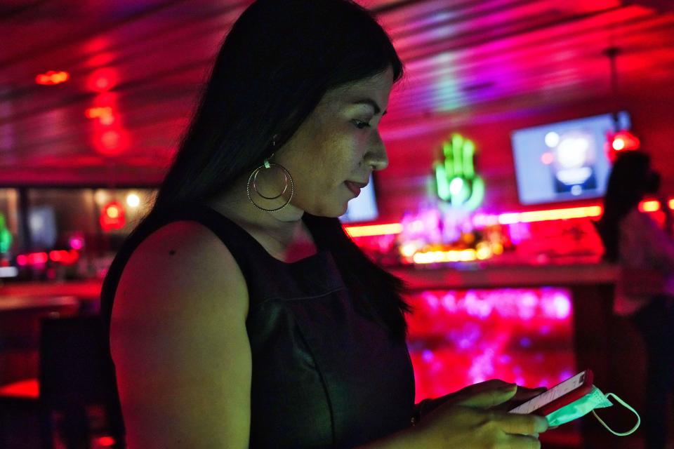 Filipina comedian Imah Dumagay prepares for her set before an open-mic night at the Hi Five Restaurant & Lounge in Dubai, United Arab Emirates, Sunday, Aug. 8, 2021. Tucked within her slightly risqué set, Dumagay's rapid-fire punchlines offer an unfiltered glimpse into the life, sly triumphs and slights faced by her 2.2 million compatriots in the Middle East. (AP Photo/Jon Gambrell)