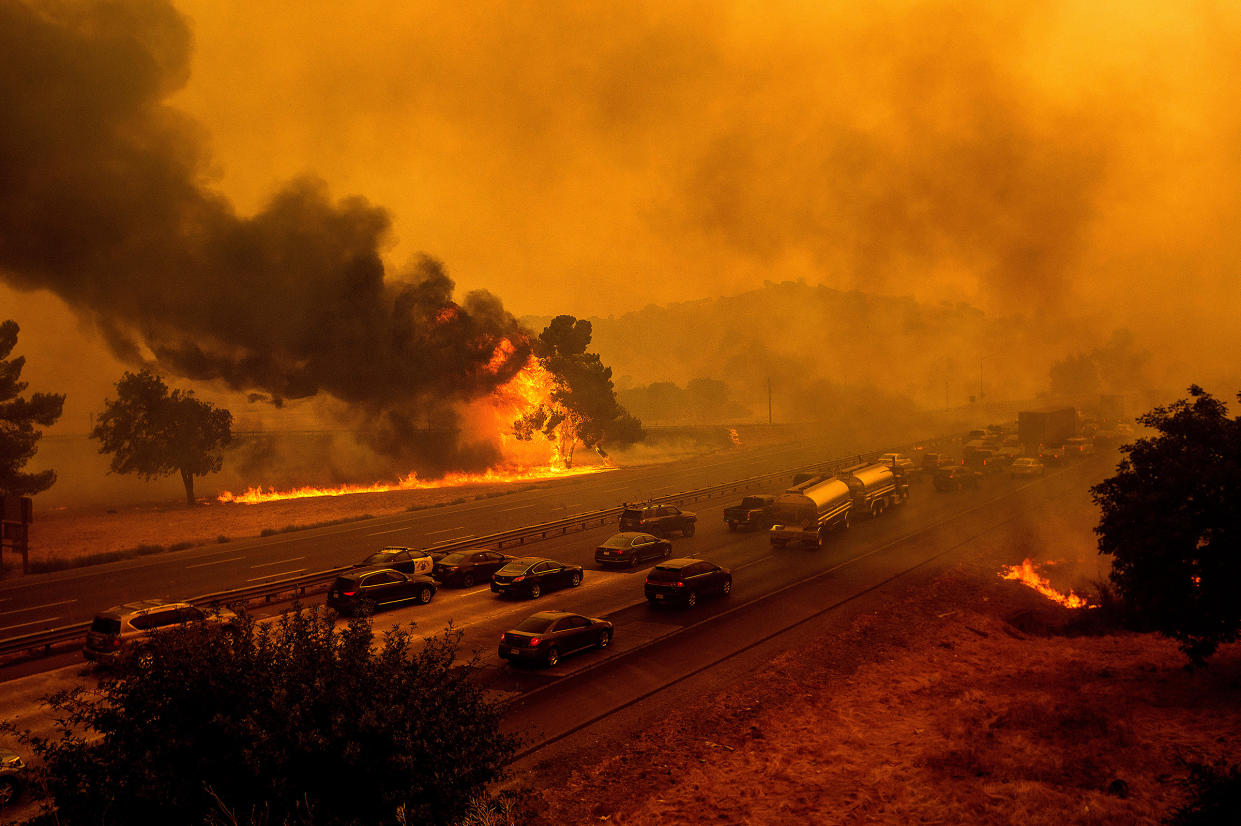 Flames from the LNU Lightning Complex fires along Interstate 80 in Vacaville, Calif., on Aug. 19, 2020. The highway was closed in both directions shortly afterward.