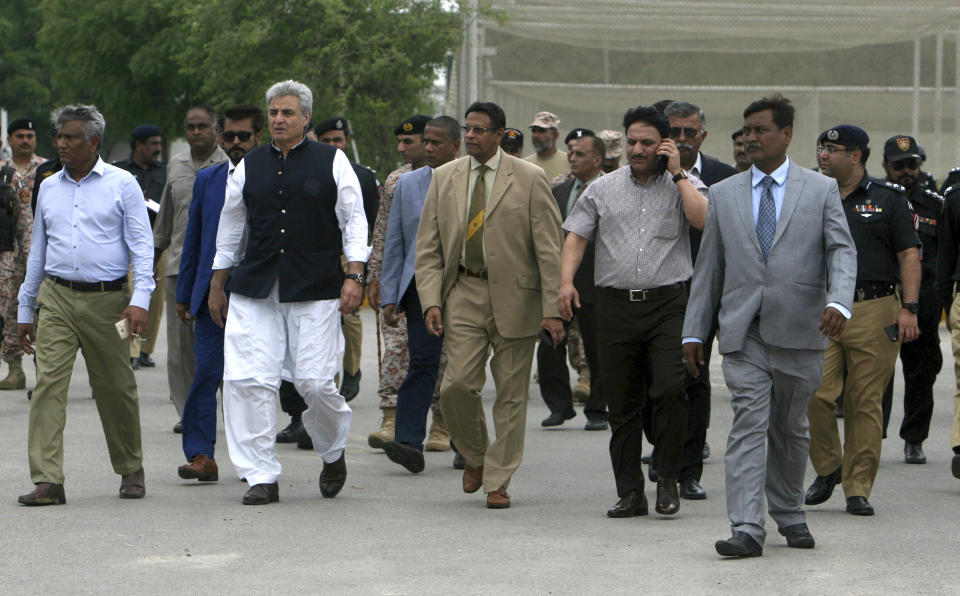 Honorary Secretary General of Sri Lankan Cricket Board Mohan De Silva, center, visits the National Stadium with Pakistani officials to review security assessments, in Karachi, Pakistan, Wednesday, Aug. 7, 2019. The delegation will present a report and on the basis the Sri Lankan Cricket Board will decide whether their test team will visit Pakistan in October. (AP Photo/Fareed Khan)