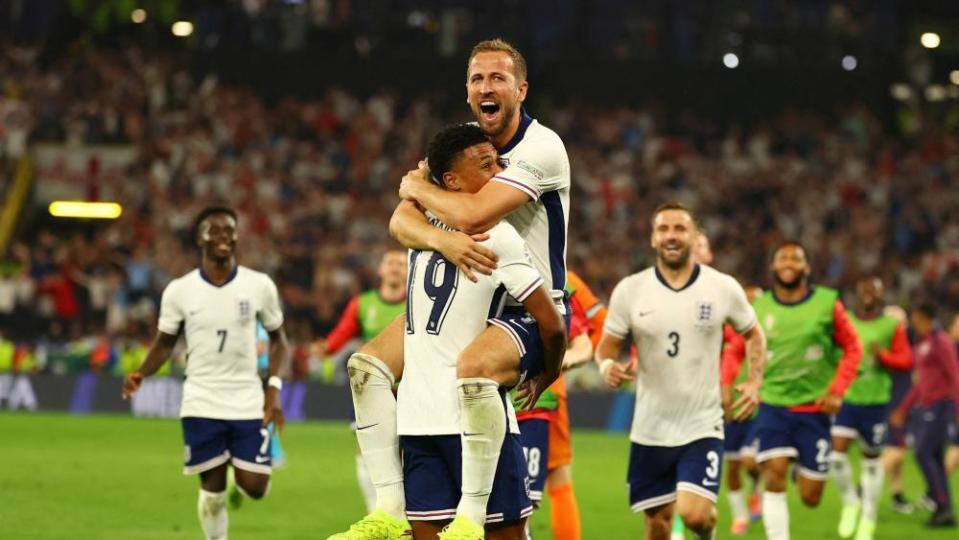 Harry Kane celebrates with Ollie Watkins after winning the match