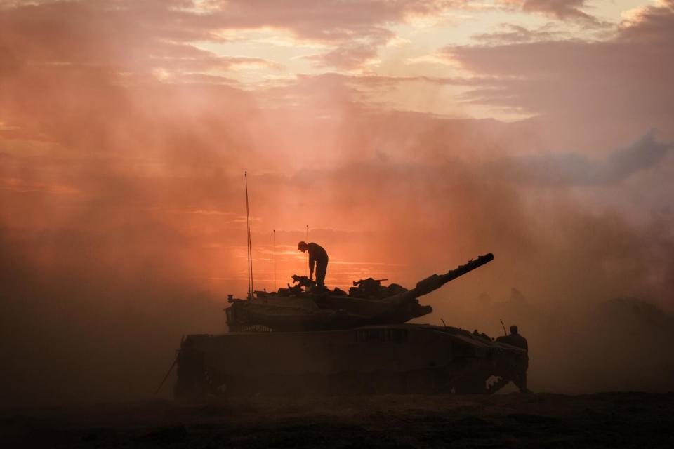 Israeli Merkava battle tank units regroup near the border of Gaza, in the southern part of Israel, on Oct. 14.