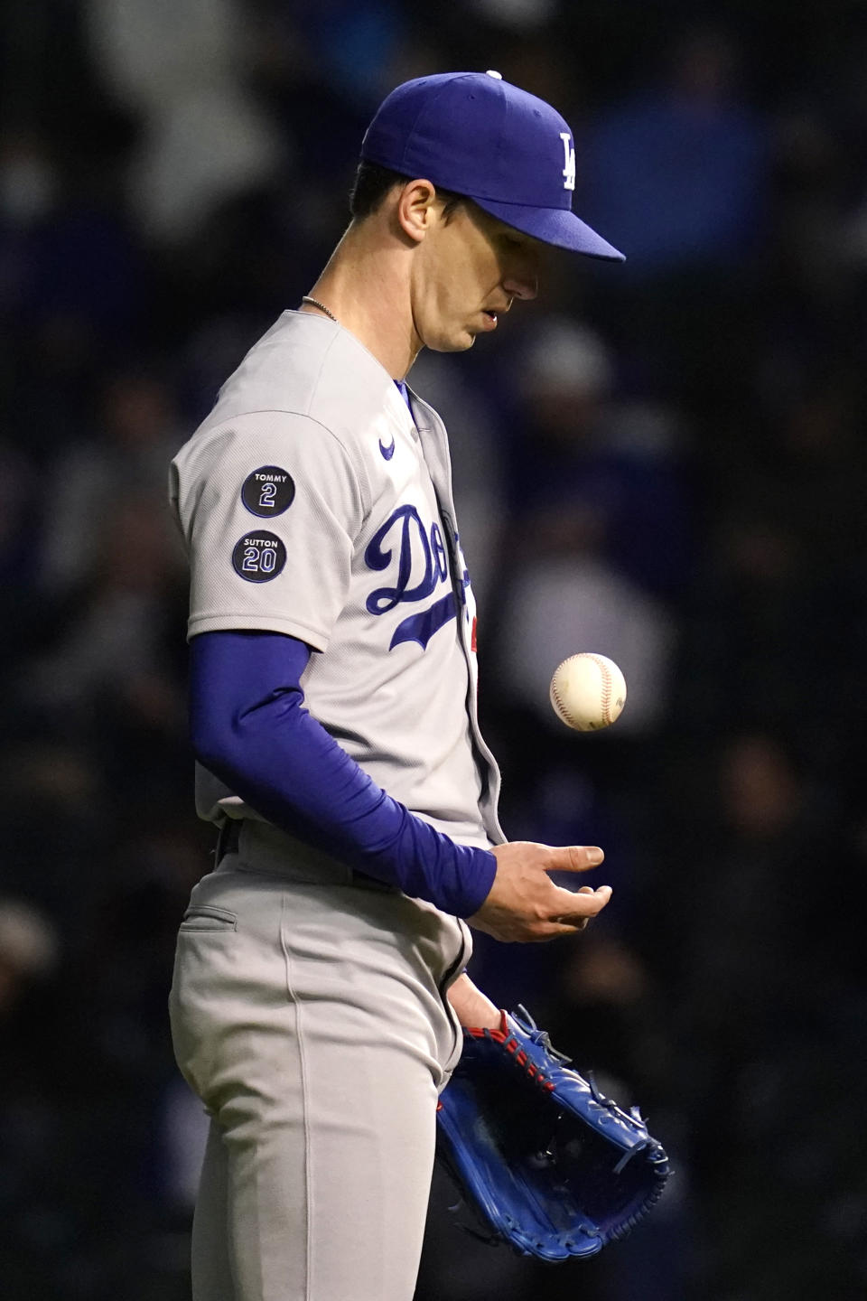 Los Angeles Dodgers starting pitcher Walker Buehler tosses the ball after Chicago Cubs' Jake Marisnick hit a two-run home run during the fifth inning of a baseball game in Chicago, Wednesday, May 5, 2021. (AP Photo/Nam Y. Huh)