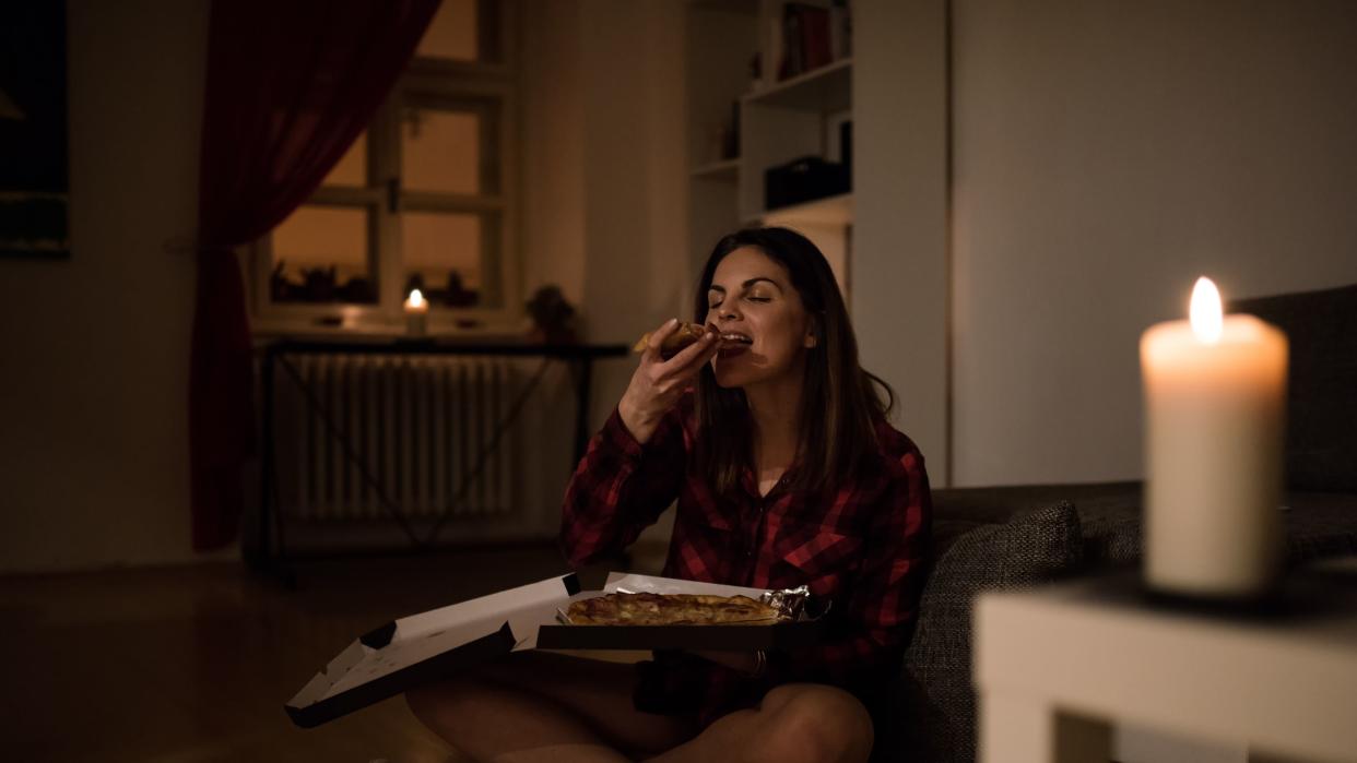 woman eating at night before bed