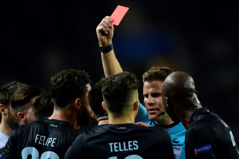 German referee Felix Brych shows a red card to Porto's Alex Telles during their UEFA Champions League against Juventus at the Dragao stadium in Porto on February 22, 2017