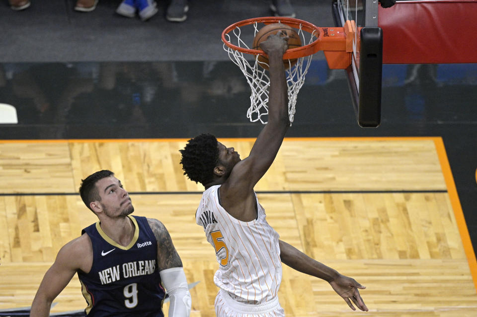 Orlando Magic center Mo Bamba (5) dunks in front of New Orleans Pelicans center Willy Hernangomez (9) during the second half of an NBA basketball game Thursday, April 22, 2021, in Orlando, Fla. (AP Photo/Phelan M. Ebenhack)