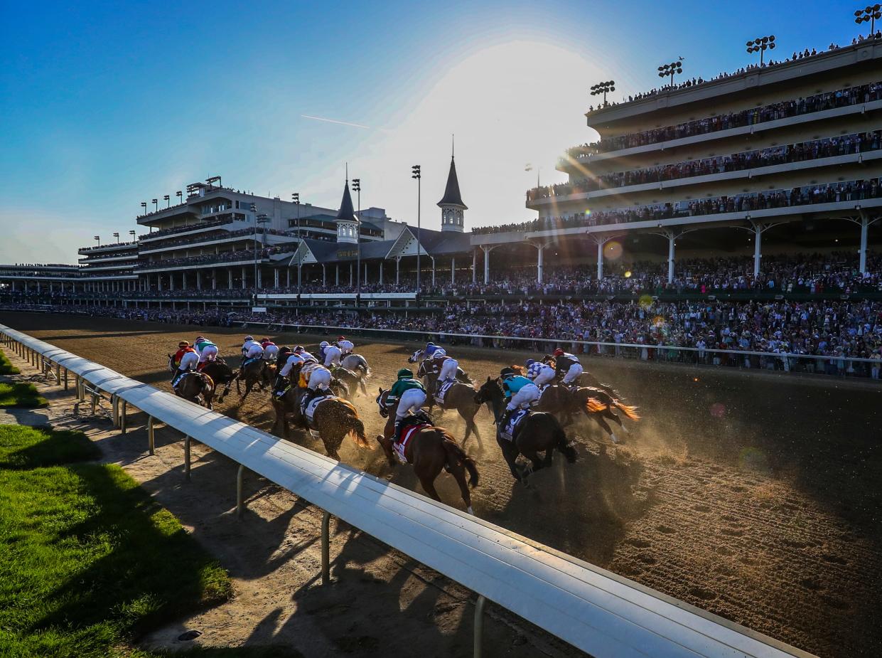 John Velazquez, aboard Medina Spirit, leads the field down the stretch to win the Kentucky Derby.