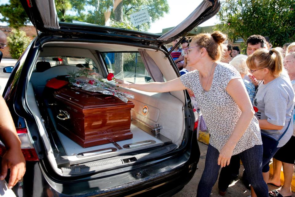 People leave flowers on Emiliano Sala's coffin at the cemetery in Santa Fe, Argentina (Natacha Pisarenko/AP)