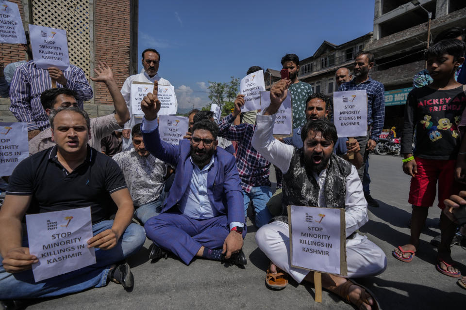 Members of JK Awami Aawaz Party hold placards as they take part in a protest against minority killings in Srinagar, Indian controlled Kashmir, Thursday, June 2, 2022. Assailants fatally shot a Hindu bank manager in Indian-controlled Kashmir on Thursday, said police, who blamed militants fighting against Indian rule for the attack. (AP Photo/Mukhtar Khan)