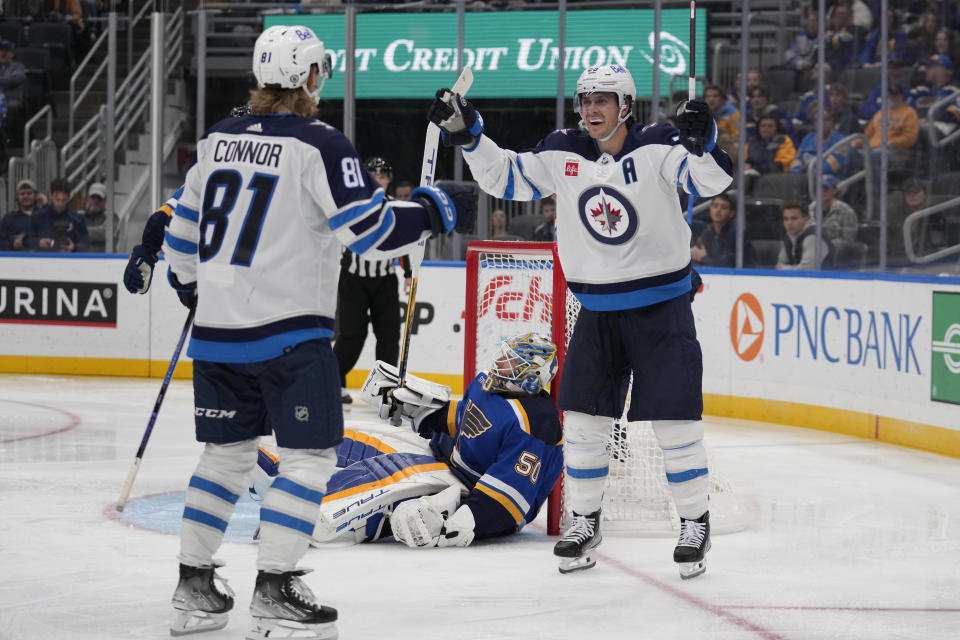 ;Winnipeg Jets' Kyle Connor (81) is congratulated by Mark Scheifele, right, after scoring past St. Louis Blues goaltender Jordan Binnington (50) during the third period of an NHL hockey game Tuesday, Nov. 7, 2023, in St. Louis. (AP Photo/Jeff Roberson)