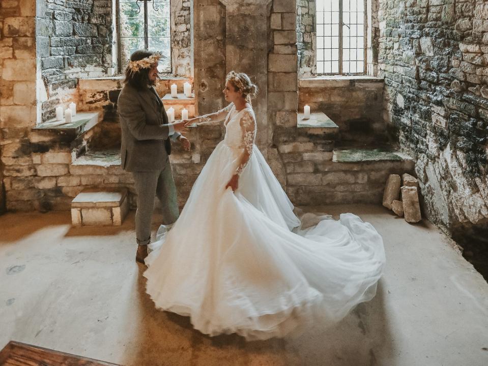 A couple dances in a church on their wedding day.