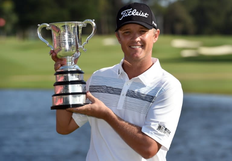 Australia's Matt Jones holds the trophy after winning the Australian Open golf tournament in Sydney on November 29, 2015