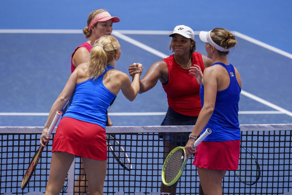 Czech Republic's Barbora Krejcikova, right, and Katerina Siniakova shake hands with US Sloane Stephens and Taylor Townsend after winning their group stage tennis doubles match at the Billie Jean King Cup finals at La Cartuja stadium in Seville, southern Spain, Spain, Friday, Nov. 10, 2023. (AP Photo/Manu Fernandez)