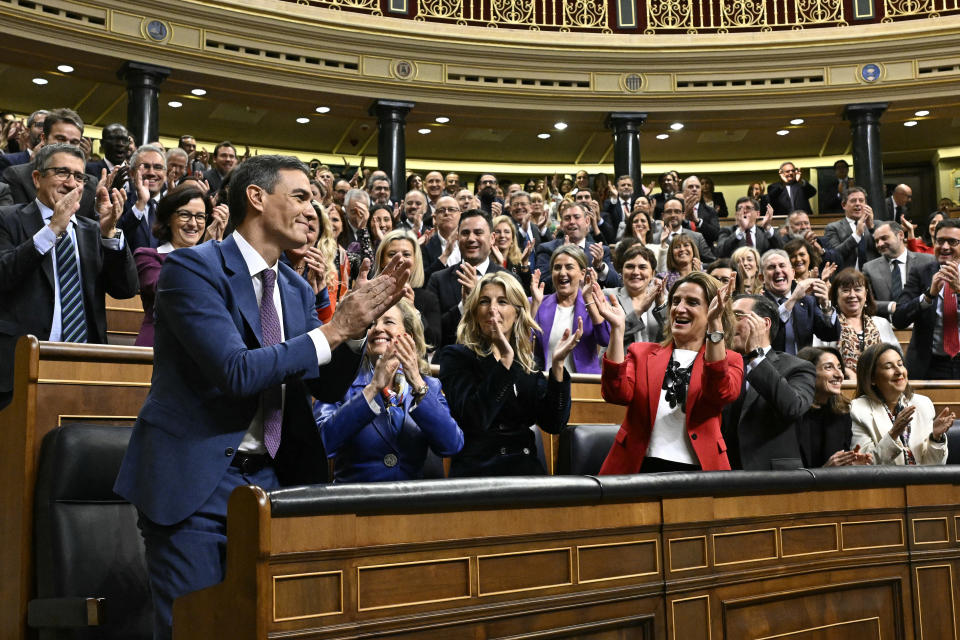 Spain's acting Prime Minister Pedro Sanchez, left, applauds with socialist deputies after he was chosen by a majority of legislators to form a new government after a parliamentary vote at the Spanish Parliament in Madrid, Spain, Thursday, Nov. 16, 2023. (Javier Soriano/Pool Photo via AP)