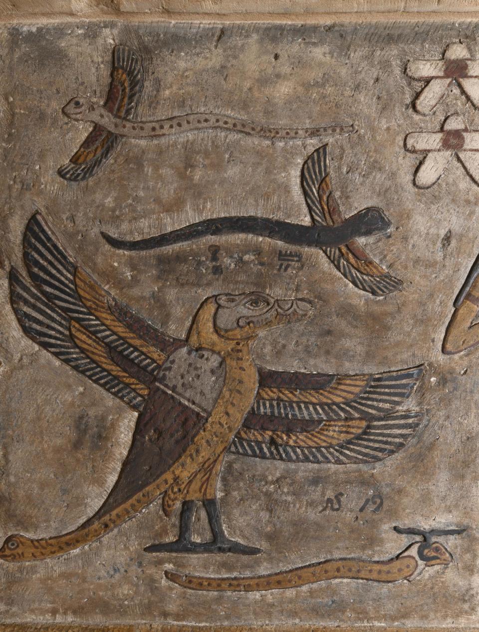 A painting shows winged snakes flying through the sky next to a mythical creature with the head of a crocodile and four wings.