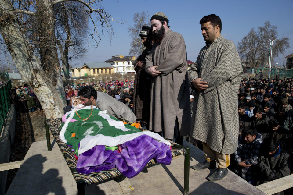 Kashmiri villagers offer prayers near the body of Murtaza, a 14-year-old civilian, in Pulwama, south of Srinagar, Indian controlled Kashmir, Saturday, Dec. 15, 2018. At least seven civilians were killed and nearly two dozens injured when government forces fired at anti-India protesters in disputed Kashmir following a gunbattle that left three rebels and a soldier dead on Saturday, police and residents said. (AP Photo/ Dar Yasin)