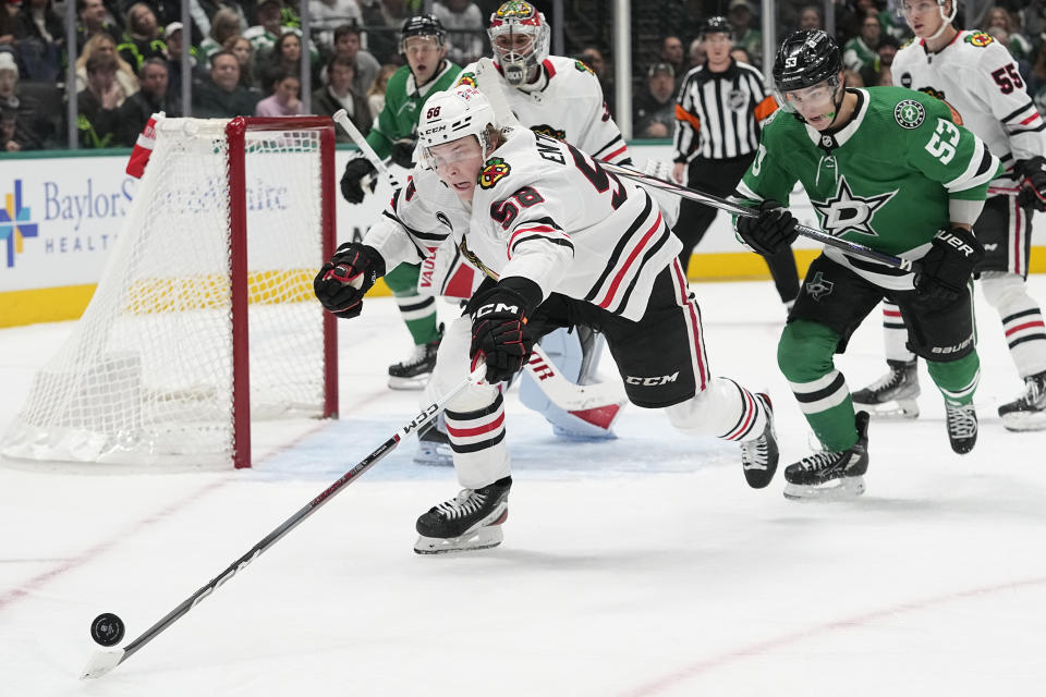 Chicago Blackhawks right wing MacKenzie Entwistle (58) skates for the puck against Dallas Stars center Wyatt Johnston (53) during the first period of an NHL hockey game in Dallas, Friday, Dec. 29, 2023. (AP Photo/LM Otero)