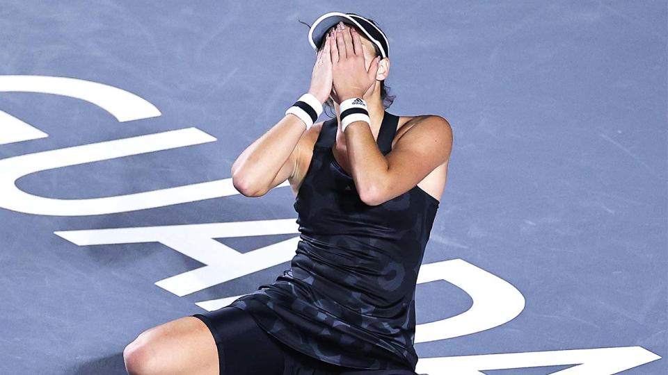 Garbine Muguruza (pictured) collapses after winning the WTA Finals.