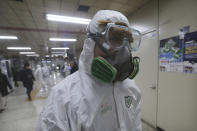 A workers wearing protective gears arrives to spray disinfectant as a precaution against the coronavirus at a subway station in Seoul, South Korea, Friday, Feb. 21, 2020. South Korea on Friday declared a "special management zone" around a southeastern city where a surging viral outbreak, largely linked to a church in Daegu, threatens to overwhelm the region's health system. (AP Photo/Ahn Young-joon)