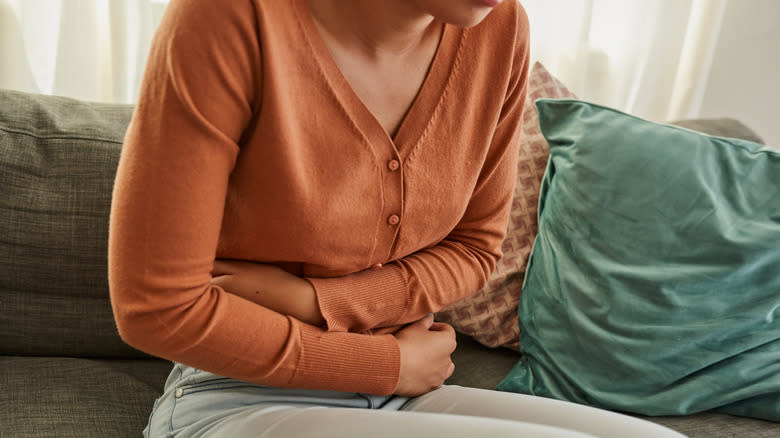 Ill woman holding stomach