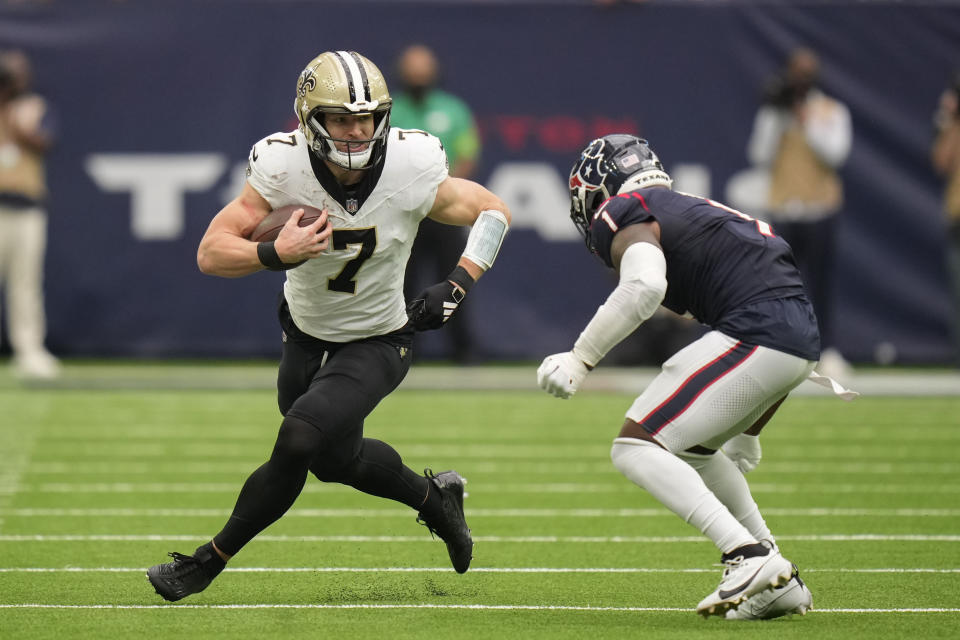 New Orleans Saints Taysom Hill (7)carries against Houston Texans safety Jimmie Ward (1) in the first half of an NFL football game in Houston, Sunday, Oct. 15, 2023. (AP Photo/Eric Christian Smith)