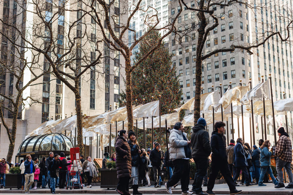 People walk passed the Rockefeller Christmas Tree. (Marc J. Franklin / NBC News)