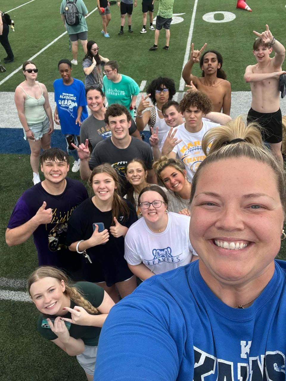 Teacher Kelli Ochsenbein takes a selfie with a few of the water balloon survivors on Senior Day at Karns High School May 11, 2023.