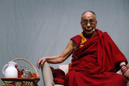 Tibetan spiritual leader the Dalai Lama looks on during a public talk at the Fraport Arena in Frankfurt May 14, 2014. REUTERS/Ralph Orlowski/Files