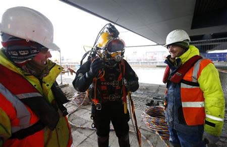 A diver prepares to enter the water to work on support structures at Crossrail's Albert Dock site in east London March 27, 2013. REUTERS/Andrew Winning