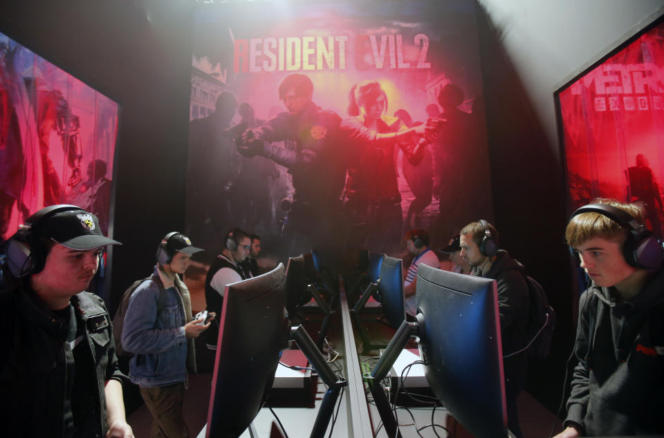 Gamers play the video game 'Resident Evil 2 Remake' developed by and published by Capcom during the 'Paris Games Week' on October 27, 2018. (Photo by Chesnot/Getty Images)